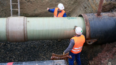 Pipe with GRP skids is pulled into the sleeve pipe